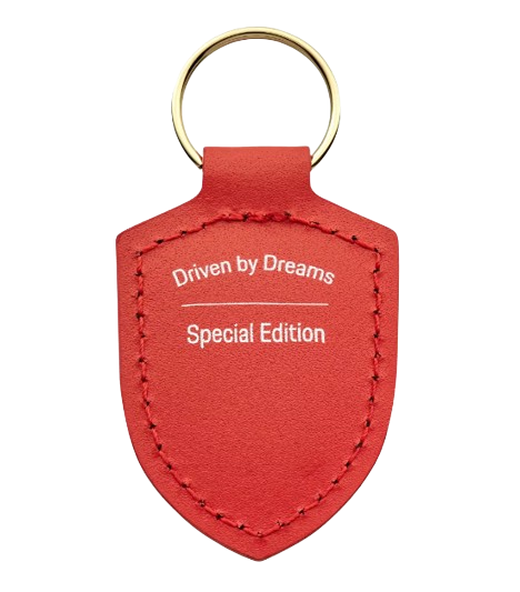 Porsche Schlüsselanhänger Wappen „Driven by Dreams“ – 75Y Lavaorange